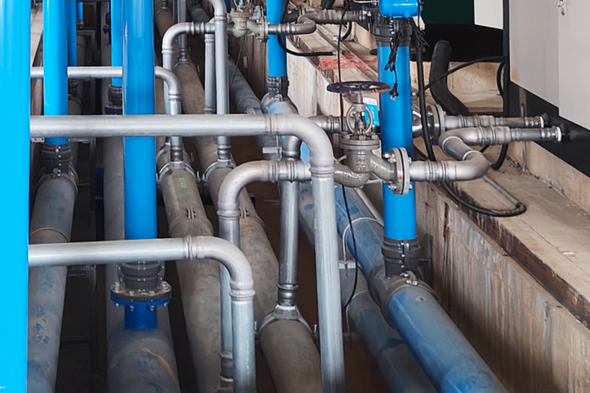 pipe-is-the-hidden-backbone crisscrossed piping network below and above flooring with different pipe sizes and materials